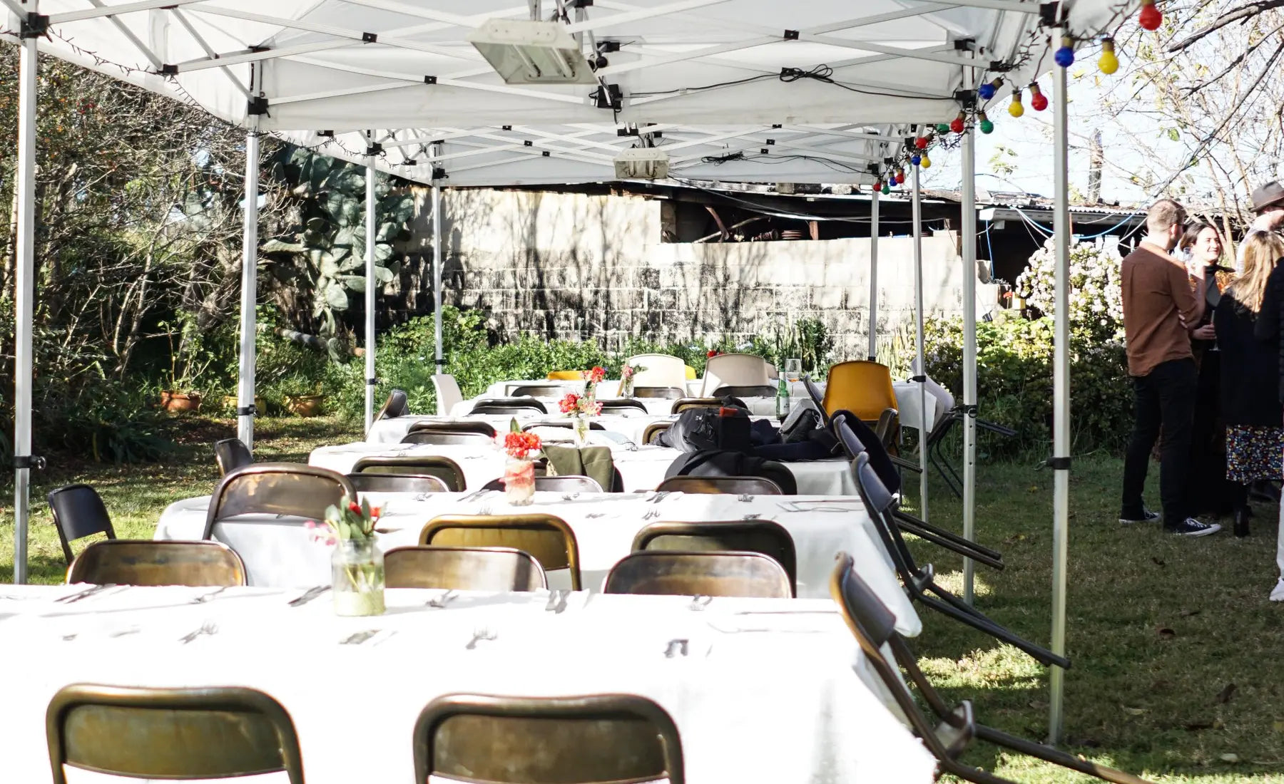 Long tables set under a canopy for an event